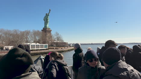 Ferry-Full-of-Tourists-Rounds-the-Back-of-Statue-of-Liberty