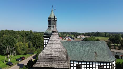 belfry-roof-and-old-half-timbered-church-on-sunny-day-aerial-circulating