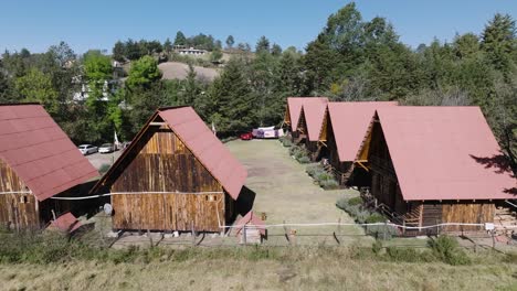 Lateral-Shot-Of-Wooden-Cottage-Cabins-At-Shinny-Morning-Time