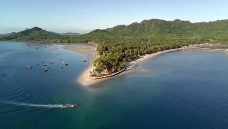 -Drone-shot-of-local-boat-passing-Siwalai-beach-on-Koh-Mook-tropical-island-in-Andaman-sea-in-Trang,-southern-Thailand