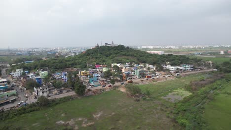 Aerial-Shot-of-Hill-in-Indian-City-Surrounded-by-Houses