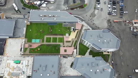 Aerial-View-of-Harstad,-Norway,-Harbor-and-Town-Buildings,-Revealing-Tilt-Up-Drone-Shot