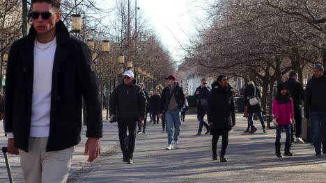 Pedestrians-in-warm-clothes-walk-in-Kungstradgarden-park-in-Stockholm