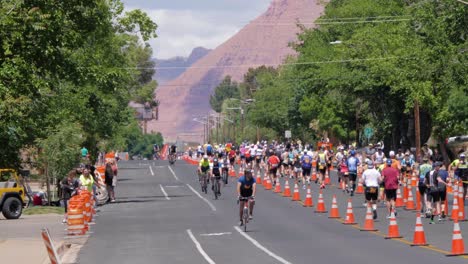 Slow-motion-shot-of-cyclists-in-front-and-runners-in-the-background-at-the-Intermountain-Health-IRONMAN-70