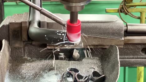 CNC-Machine-Working-cutting-metal-pipe-with-coolant-liquid