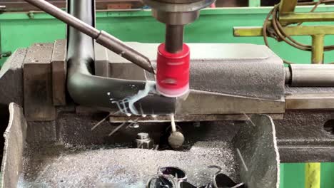 Milling-machine-is-cuting-the-irone-plate-pipe-using-coolant-liquid