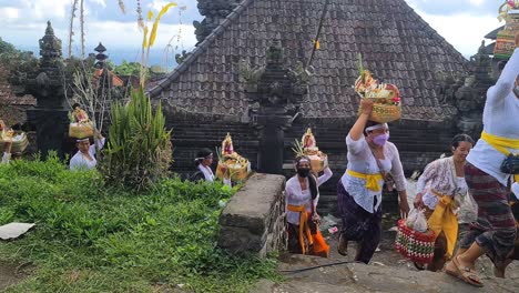 Group-of-Balinese-Women-With-Basket-on-Head-Walking-by-Hindu-Temple-During-Ceremony-Celebration,-Besakih-Temple,-Bali-Island,-Indonesia
