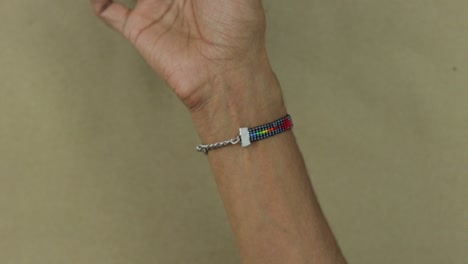 Close-up-of-man-arm-wearing-a-LGBT-bracelet-made-with-beads