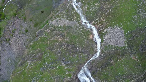 Aerial-shot-of-Cascata-di-Stroppia-with-Lago-Niera,-lush-greenery,-and-rugged-terrain,-daylight