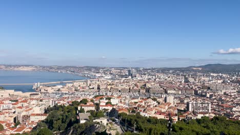 Slow-wide-pan-of-sunny-port-area-in-city-of-Marseille-in-France