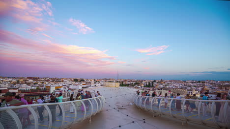 People-Walk-along-Cerro-de-la-Encina-sightseeing-point-in-Granada-Spain-sunset-time-lapse-skyline-moving,-pink-clouds,-blue-horizon,-Historical-landmark