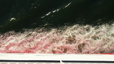 Top-down-shot-of-water-passing-around-the-hull-of-a-ferry