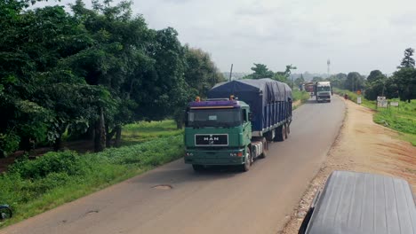 Trucks-transporting-cargo-along-a-highway-in-Gboko,-Nigeria