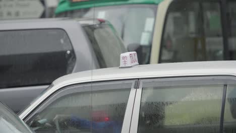 Hong-Kong-taxi-driving-in-heavy-traffic-during-an-overcast-and-rainy-day---Slow-Motion