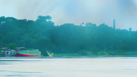 Static-view-of-small-fishing-boat-on-Surma-river,-Bangladesh,-air-pollution-smog