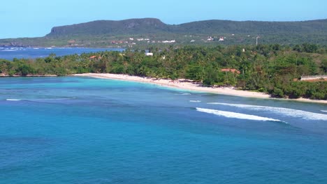 Blue-sea-with-Playa-La-Playita-beach-in-background,-Las-Galeras-landscape-in-Samana-peninsula,-Dominican-Republic
