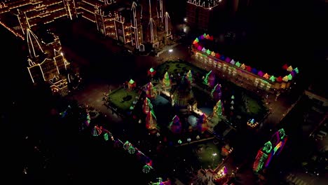 Aerial-drone-view-phone-moving-towards-Camero-where-the-big-temple-is-looking-very-beautiful-with-lights-and-many-people-are-coming-in-and-looking