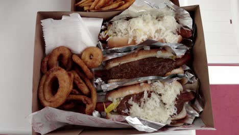 Hot-dogs,-fries-and-onion-rings-from-Pink's-Hot-Dogs-in-Los-Angeles,-California-with-video-moving-down