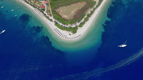 Aerial:-Panoramic-drone-shot-of-the-beautiful-beach-at-Agios-Dimitrios,-Alonnisos-island,-Sporades,-Greece,-with-emerald-and-turquoise-sea