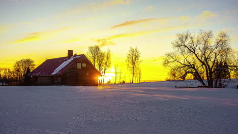 Snowy-landscape-and-home-during-bright-sunrise,-time-lapse-view