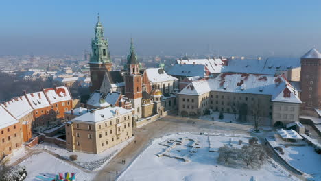 Panorama-of-snow-covered-Wawel-castle-at-magic-morning-with-soft-sun-light-during-winter,-Krakow,-Poland