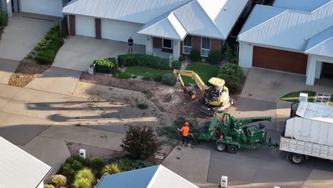 Yarrawonga,-Victoria,-Australia---6-March-2024:-Aerial-of-a-tree-felling-machine-and-wood-chipper-machine-working-in-a-suburban-street-in-Yarrawonga