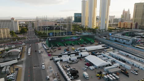 Aerial-view-backwards-over-a-formula-one-ad-billboard,-sunrise-in-Las-Vegas,-USA