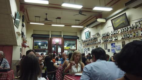Argentine-people-have-dinner-at-traditional-old-restaurant-in-Buenos-Aires-city,-local-people-eat-pasta-in-Italian-heritage-canteen-at-night,-south-America-travel-destination