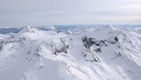 Snow-Capped-Winter-Mountain-Landscape,-Aerial-View-from-Airplane