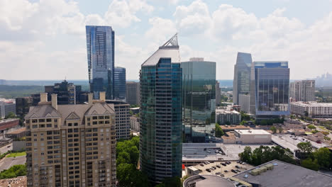 Aerial-orbit-shot-Skyline-in-Atlanta-with-modern-mirrored-high-rise-towers-at-sunny-day
