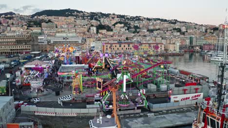 Amusement-park-rides-at-Genoa-Winter-Park,-Ponte-Parodi,-aerial-trucking-view