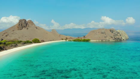 Flight-over-turquoise-water-of-Pantai-Merah-On-Padar-Island-in-Komodo-National-Park,-Indonesia