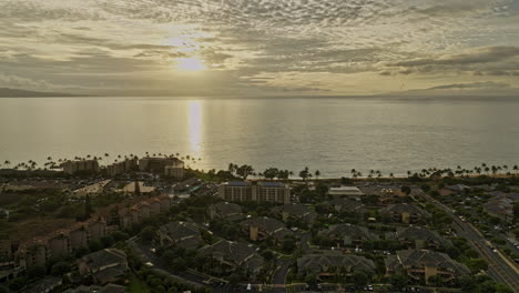 Kihei-Maui-Hawaii-Aerial-v2-Hawaiian-coastal-landscape,-drone-flyover-residential-areas-capturing-Kamaole-Beach-Park-and-oceanscape-with-golden-sunset-views---Shot-with-Mavic-3-Cine---December-2022