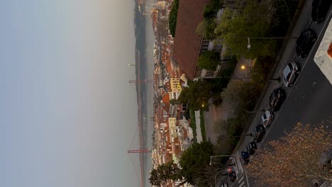 Vertical-timelapse-view-of-the-red-bridge-in-the-city-of-Lisbon,-Portugal-in-the-evening
