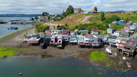 Aerial-view-tilting-over-Palafitos-stilt-houses-on-the-shore-of-Castro,-Chiloe