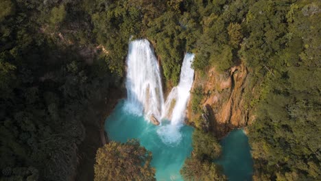 Aerial-view-of-heavenly-waterfalls-and-a-turquoise-river-in-the-tropical-forest