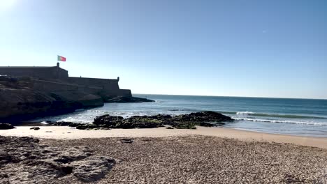 Carcavelos-beach-with-the-fortress-or-Fort-of-São-Julião-da-Barra,-the-largest-and-most-complete-military-defense-complex-in-the-Vauban-style-remaining-in-Portugal