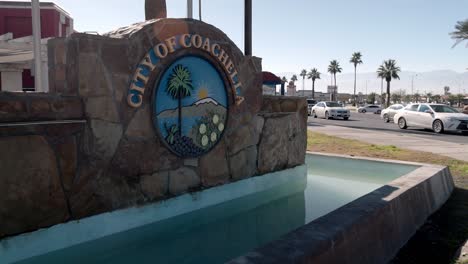 City-of-Coachella,-California-sign-with-cars-moving-in-the-background-and-stable-video