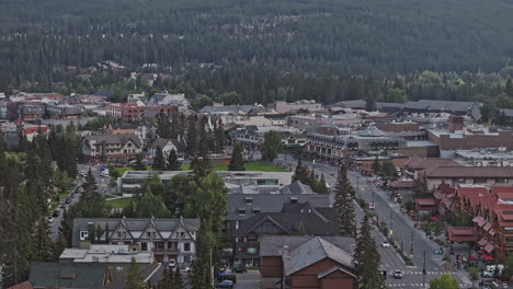 Banff-AB-Canada-Aerial-v6-zoomed-drone-flyover-town-center-capturing-townscape-with-quaint-streets-lined-with-shops-and-restaurants-and-Bow-river-views---Shot-with-Mavic-3-Pro-Cine---July-2023