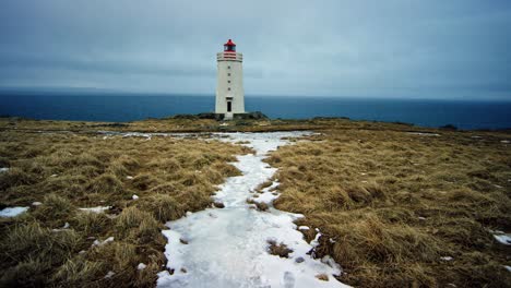 Eine-Luftaufnahme-In-4K-Zeigt-Einen-Hoch-Aufragenden-Leuchtturm-In-Island,-Umgeben-Von-Weiten-Offenen-Landschaften