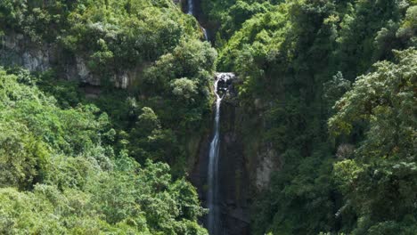 Tracking-clip-going-upward-along-a-beautiful-large-waterfall-in-Puichig,-Ecuador