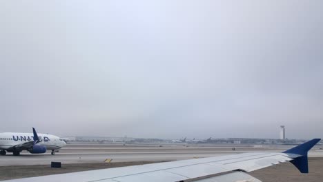 Airplane-Passenger-View-United-Airlines-Plane-Taking-Off-Overcast-Day