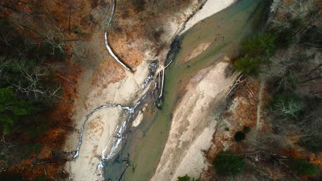 Rising-aerial-view-of-a-river's-sedimentation-after-severe-weather-conditions