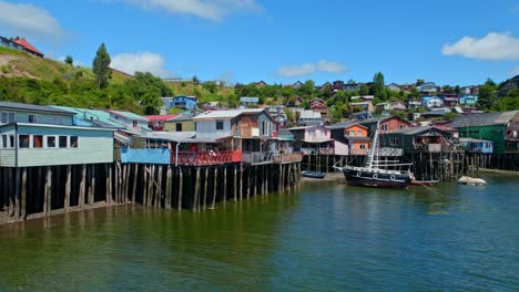 Colorful-Traditional-Stilt-Houses-In-Castro,-Chiloe-Island,-Chile-4K-Drone-Flyover