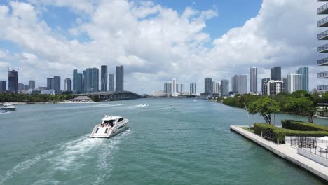 Miami,-Florida-USA,-Aerial-View-of-Boat-in-Biscayne-Bay-by-Venetian-Islands-WIth-Downtown-Skyline-in-Background,-Drone-Shot
