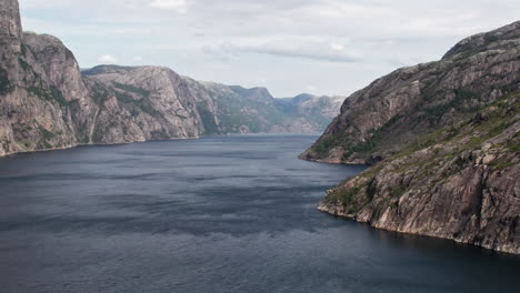 Aerial-shot,-panning-sideways-over-the-wide-windswept-waters-of-Lysefjord,-Norway