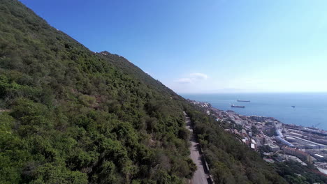 Rock-of-Gibraltar-and-city-bellow,-aerial-side-view