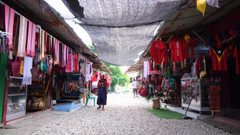 Timorese-woman-wandering-around-the-stalls-at-tourism-Tais-Market-with-souvenirs-n-the-capital-city-of-East-Timor,-Southeast-Asia