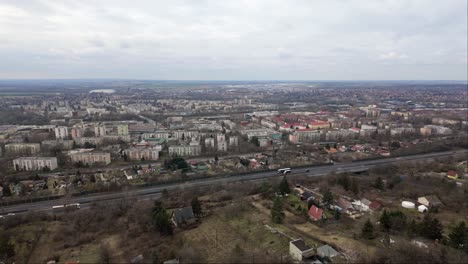 Hungary,-Tatabánya-industrial-town-and-surroundings-behind-the-M7-motorway-during-winter-on-a-cloudy-day
