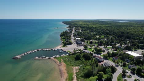 Drone-aerial-view-of-the-entire-city-of-Bailey's-harbor,-Wisconsin-on-a-sunny-day